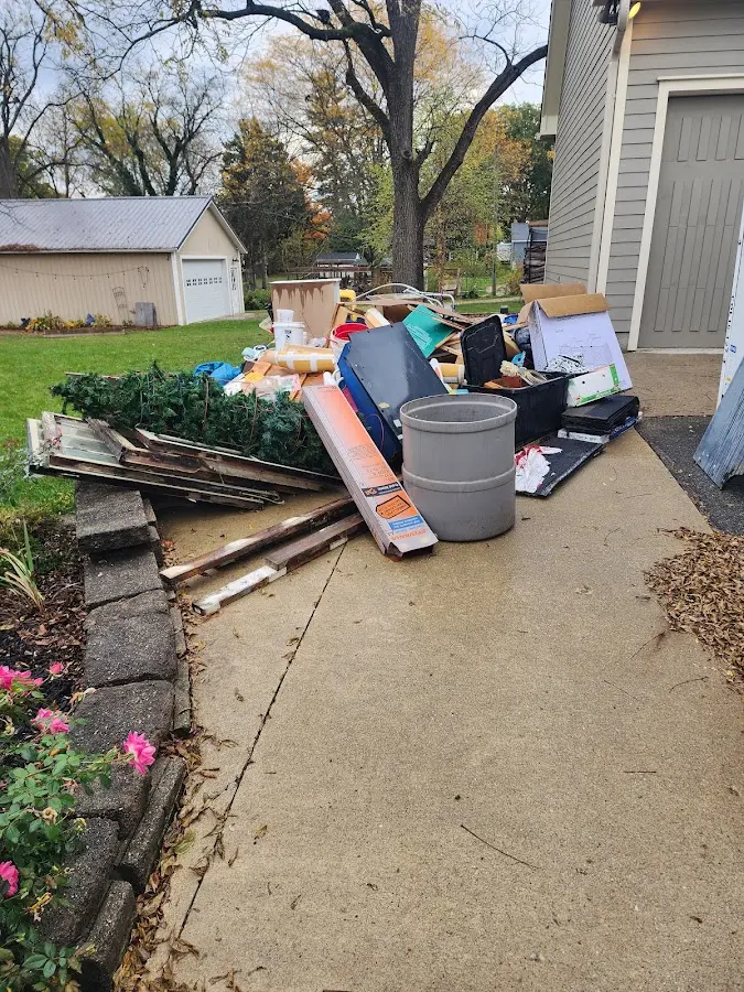 Dumpster being loaded with debris for 10 Yard Dumpster Rental in Owego
